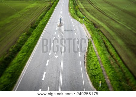 Highway Road With White Stripes With Rural Fields On Both Sides Seen From Above