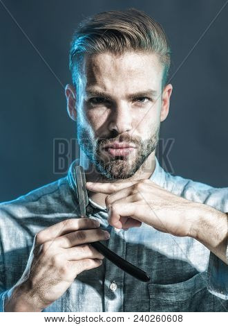 Stylish Hairdresser With Dangerous Razor For Shaving In Studio. Portrait Brutal Caucasian Hipster, M