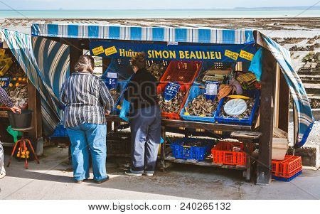 Cancale, France - October 6, 2009: Tourists And Locals Buying Oysters At Small Market In Cancale Nea