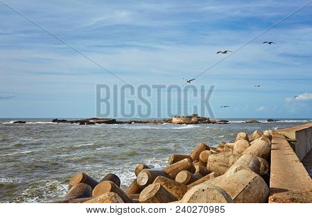 Port Of Essaouira In Morocco With Local Fishing Boats, Seagulls And Fishing Nets On A Sunny Day Soft
