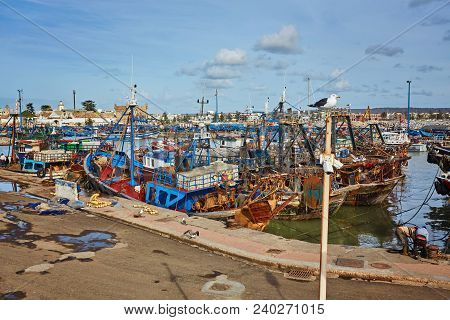 Port Of Essaouira In Morocco With Local Fishing Boats, Seagulls And Fishing Nets On A Sunny Day Soft