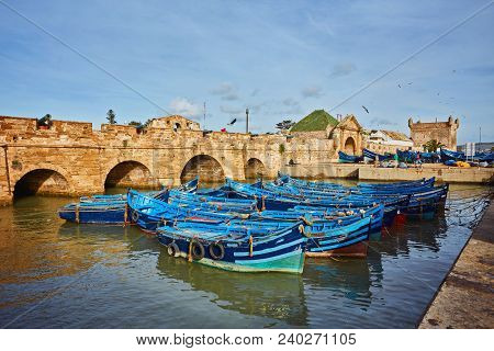 Fort Of Essaouira In Morocco On A Sunny Day With Blue Boats On The Water And Selective Focus
