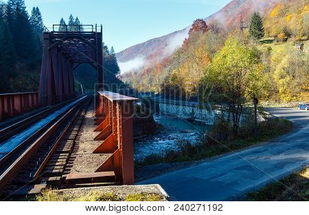 Autumn Carpathian Mountains Misty Landscape With  Railroad Bridge, Mountain Tysa River, Dam And Road