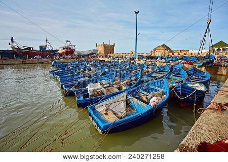 Fort Of Essaouira In Morocco On A Sunny Day With Blue Boats On The Water And Selective Focus