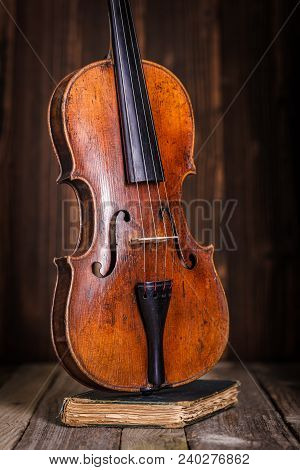 Front View Of A Classical Old Violin On Wooden Background