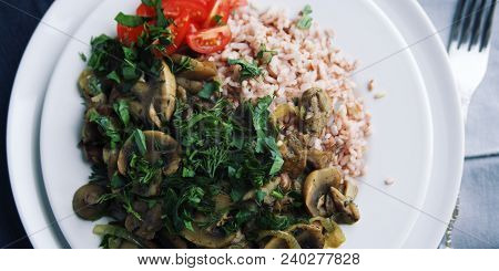 Red Rice With Mushrooms And Cherry Tomatoes. Vegan Dish. European Cuisine. Simple Healthy Lunch. Veg