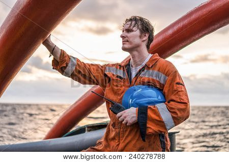 Deck Officer On Deck Of Offshore Vessel Or Ship , Wearing Ppe Personal Protective Equipment. He Hold