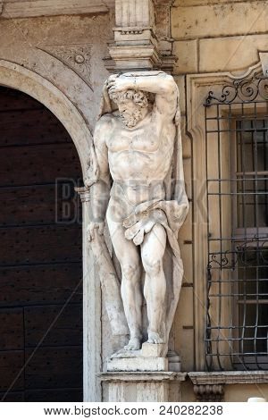 MANTUA, ITALY - JUNE 04: Statue of Hercules at the entrance to the 18th century Palazzo Vescovile (Bishops Palace) in the historical center of Mantua, Italy on June 04, 2017.
