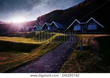 A Small Wooden Church And Cemetery Hofskirkja Hof, Skaftafell Iceland. Scenic Sunset Through Tree Cr