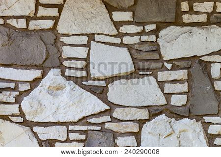 Wall Background With Irregular Sized White And Brown Stones