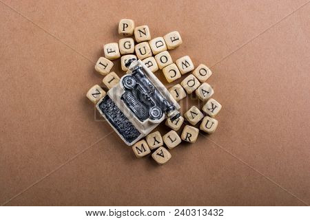 Letter Cubes Of Made Of Wood Around Model Typewritter