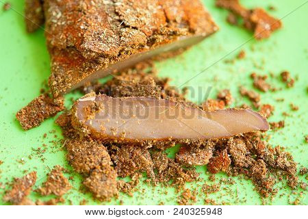 Cuts Of Pepper Basturma On Green Background