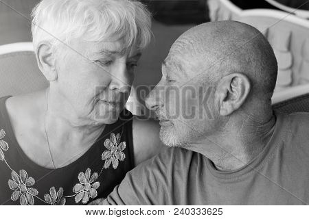 Black And White Sweet Tender Indoor Shot Of Happy Mature Couple Hugging And Cuddling At Cafe: Caucas
