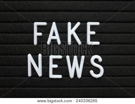 The Words Fake News In White Plastic Letters On A Black Letter Or Bulletin Board
