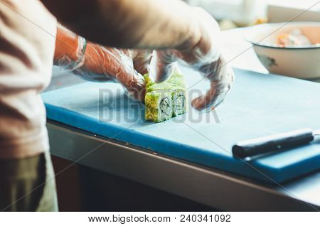 Professional Chef, Chef The Process Of Making Sushi Rolls, Spins Bamboo Mat And Cut Slices