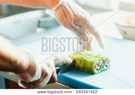 Professional Chef, Chef The Process Of Making Sushi Rolls, Spins Bamboo Mat And Cut Slices
