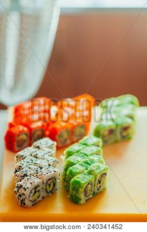 Professional Chef, Chef The Process Of Making Sushi Rolls, Spins Bamboo Mat And Cut Slices