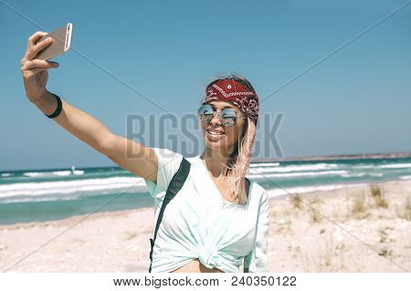 Young Woman Resting On The Sand Beach And Taking Photo With Mobail Phone