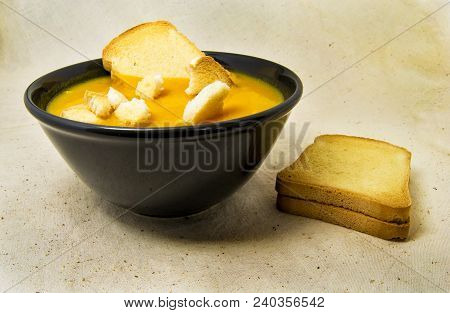 Delicious Pumpkin Pured Soup With Potatoes And Zwiebacks Bread Slices. For Vegetarian, Vegan And Hea