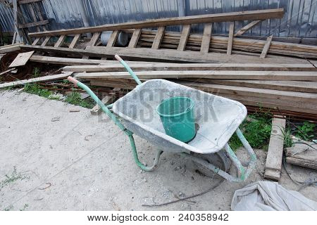 Image Of Old Used Dirty Wheelbarrow Outdoors