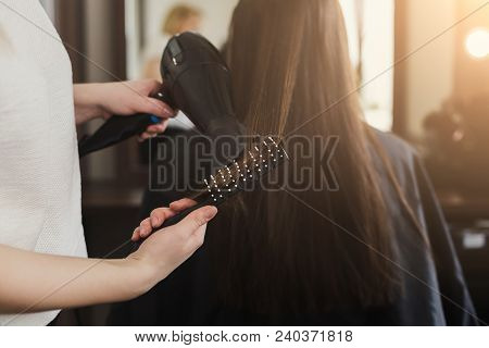 Beautician Drying Woman's Hair