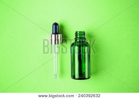 Minimal Style Minimalist Photo Of Skin Care, Packaging For Cosmetics. Glamorous. Green Glass Bottle 