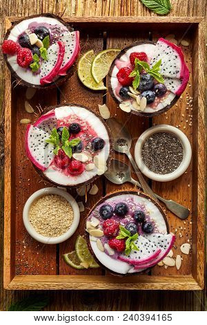 Berry Smoothie In A Coconut Bowl With Fresh Pitaya Fruit (dragon Fruit), Blueberries And Raspberries