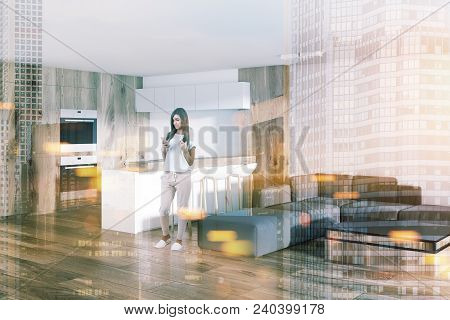 Woman In A Studio Apartment Kitchen And Living Room With A Wooden Bar And Built In Apliances. Concep