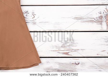 Female Brown Skirt And Copy Space. Women Long Vintage Skirt On White Wooden Background. Feminine Gar