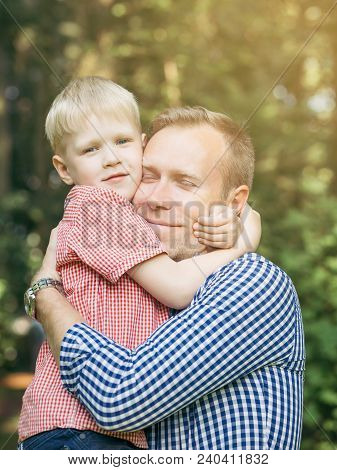 Father And Son Hugging And Smiling In The Garden. Masculinity Concept. Blondy People. Family.