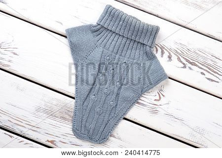 Colorful Knitting Cowl, Top View. Female Knit Neck Warmer Of Blue Color On Wooden Background. Female