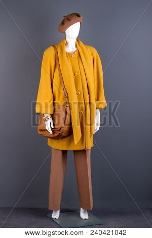 Full Length Female Mannequin In Fashion Outfit. Ladies Modern Topcoat, Handbag And Headgear. Women S