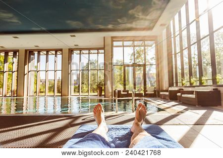 Man Enjoying The Summer By The Pool.