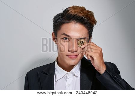 Golden Bitcoin In A Man Hand, Digitall Symbol Of A New Virtual Currency