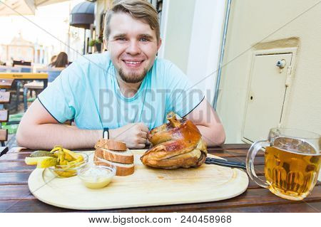 Young Man Going Drnk Beer And Eat Snacks.