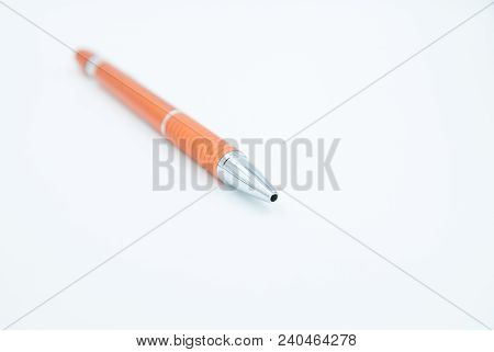 Orange Pencil With Silver Top On White Background