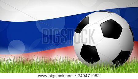 Soccer Ball Lying In The Grass In Front Of Russian Flag