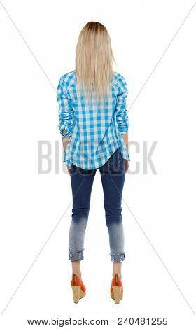 Back view of a woman in jeans. girl  watching. Rear view people collection.  backside view of person. Isolated over white background. The blonde in the shirt dropped her hands down