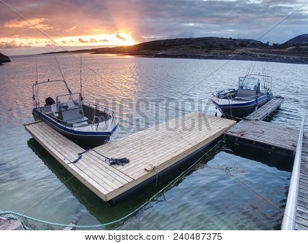 Fishing Boat With Fishing Rods Floating At Shore, Evening Colorful  Sea. Background Beautiful Sky