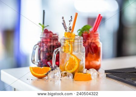 Various Lemonades In Mason Jars With Orange Lime Lemon Otange Strawberries And Fresh Fruit Fruits