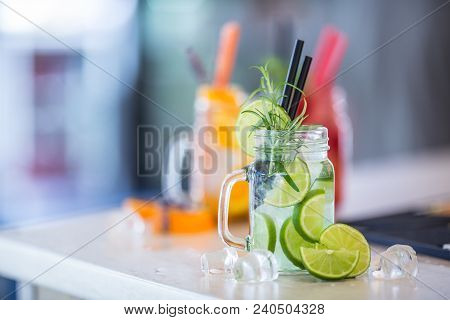 Various Lemonades In Mason Jars With Orange Lime Lemon Otange Strawberries And Fresh Fruit Fruits