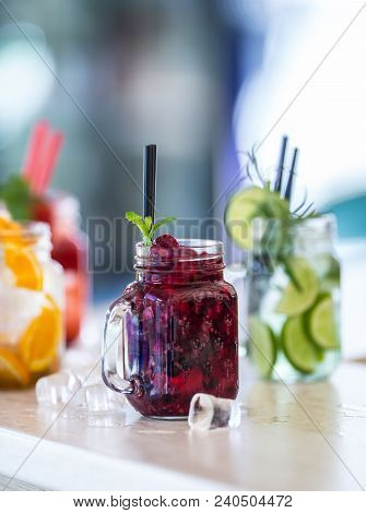 Various Lemonades In Mason Jars With Orange Lime Lemon Otange Strawberries And Fresh Fruit Fruits