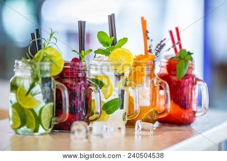 Various Lemonades In Mason Jars With Orange Lime Lemon Otange Strawberries And Fresh Fruit Fruits