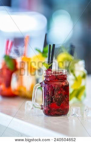 Various Lemonades In Mason Jars With Orange Lime Lemon Otange Strawberries And Fresh Fruit Fruits