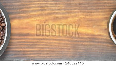 A Cup Of Coffee And A Saucer With Coffee Beans Are Located On The Sides Of The Photo On A Wooden Bac
