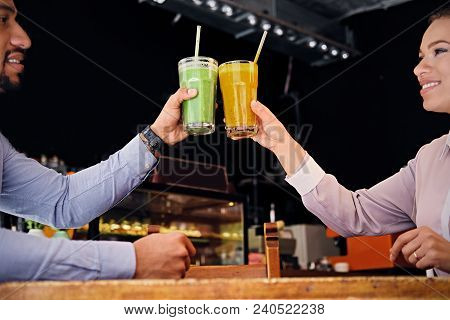 Black American Couple Talks And Drinks, Fresh Juice At A Cafe
