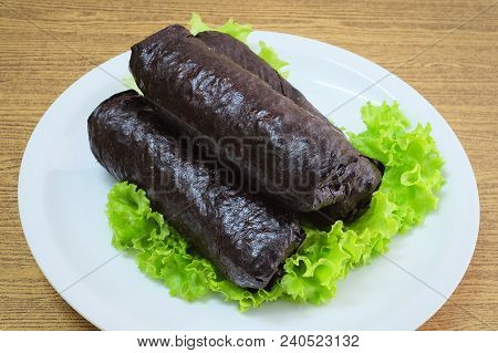 Japanese Cuisine, Traditional Unsliced Japanese Rice Maki Sushi Roll With Nori Seaweed Served On Gre