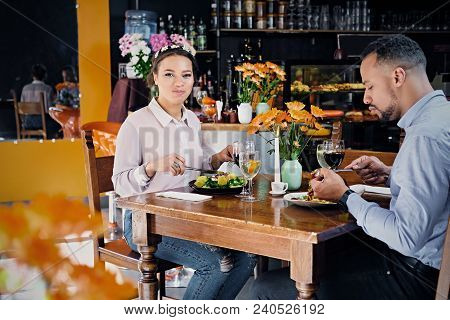 Black American Male And Female Eating Vegan Food In A Restaurant.