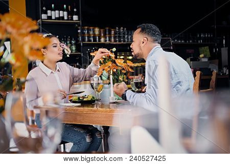 Black American Male And Female Eating Vegan Food In A Restaurant.