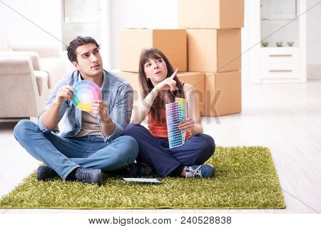 Young family choosiing colours for new apartment